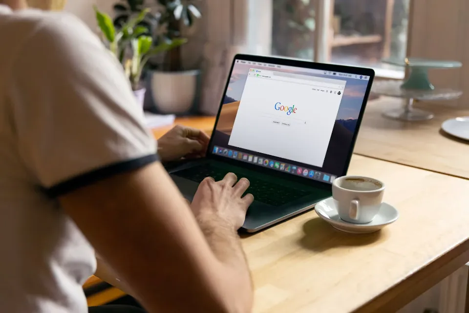 Person searching on Google using a laptop